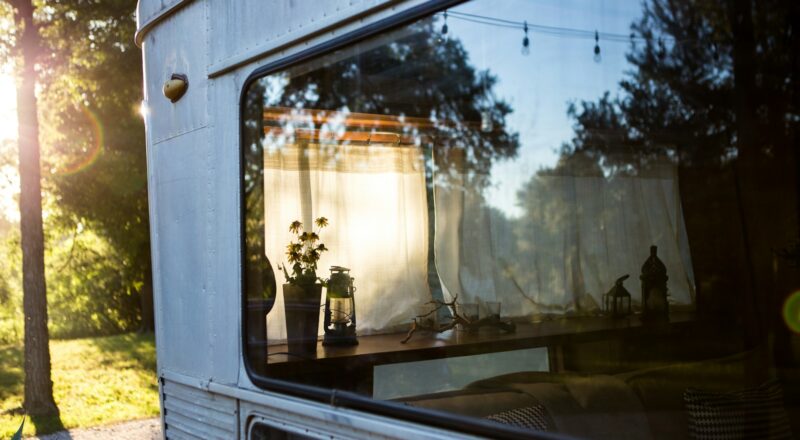 trees reflecting on caravan window